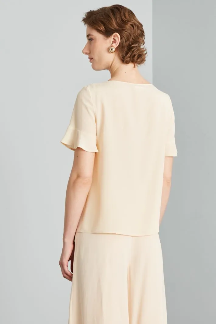 Blusa con pieghe ribattute